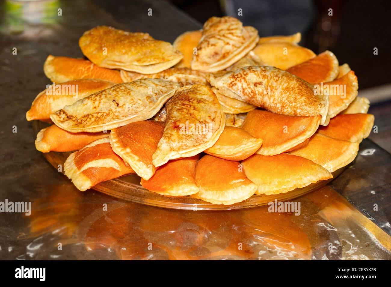 Qatayef or Katayef, is an Arab dessert commonly served during the month of Ramadan, a sort of sweet dumpling filled with cream or nuts. Stock Photo