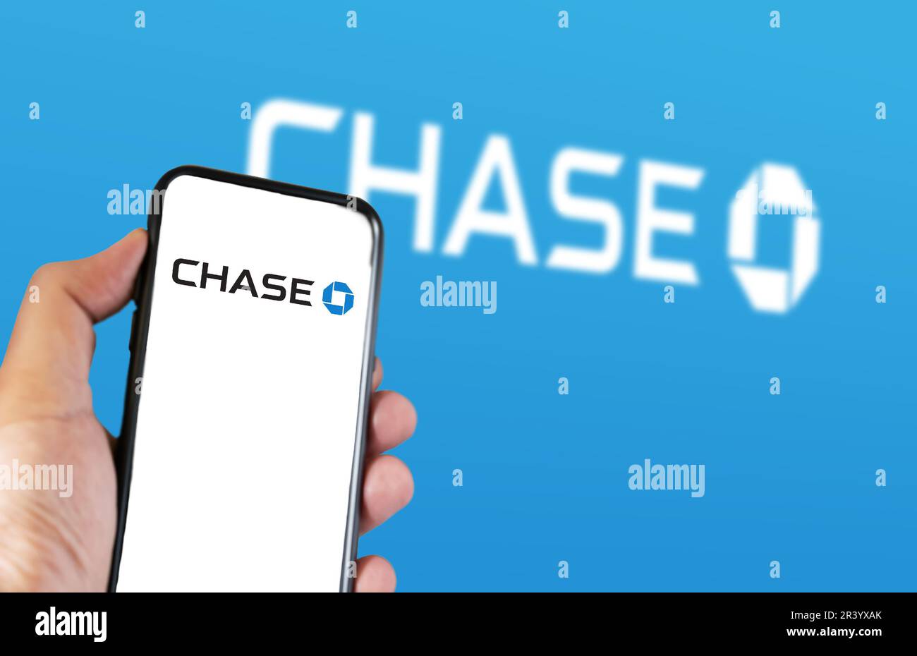 New York, US, March 2023 Hand holding a phone with Chase logo