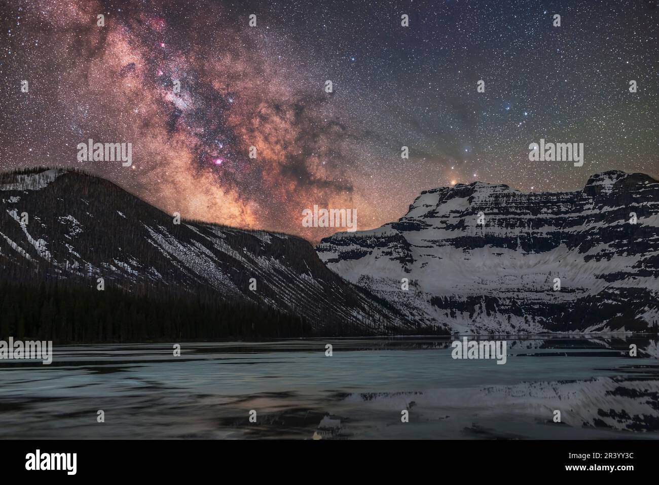 The Milky Way, with the star clouds of the galactic core over Cameron Lake in Alberta, Canada. Stock Photo