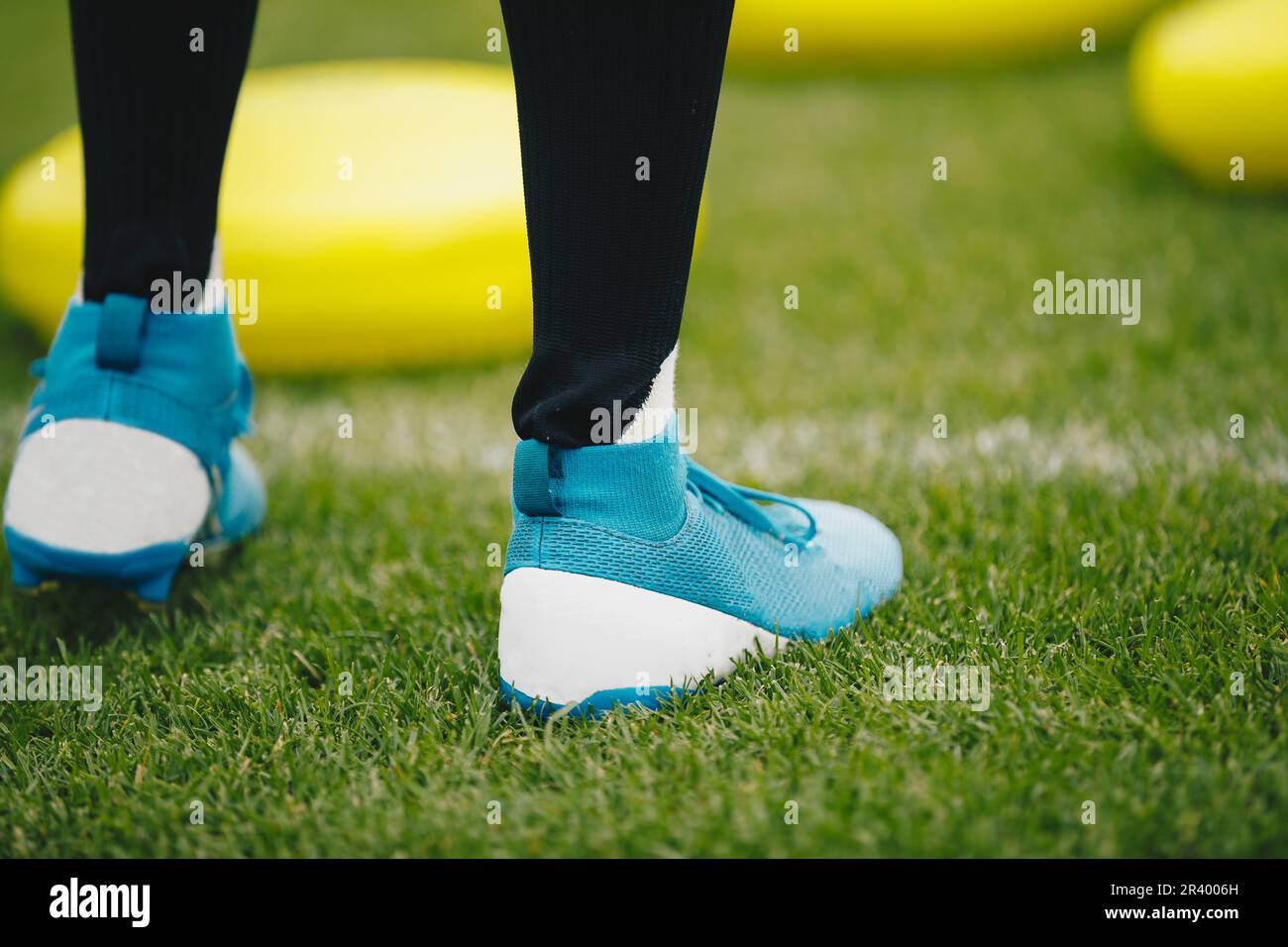 Soccer player in soccer turf cleats at training class. Footballer