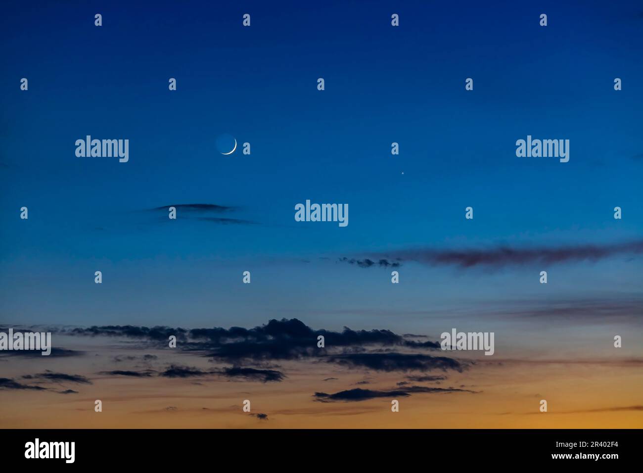 The two-day-old waxing crescent moon near Mercury in the evening sky, Alberta, Canada. Stock Photo