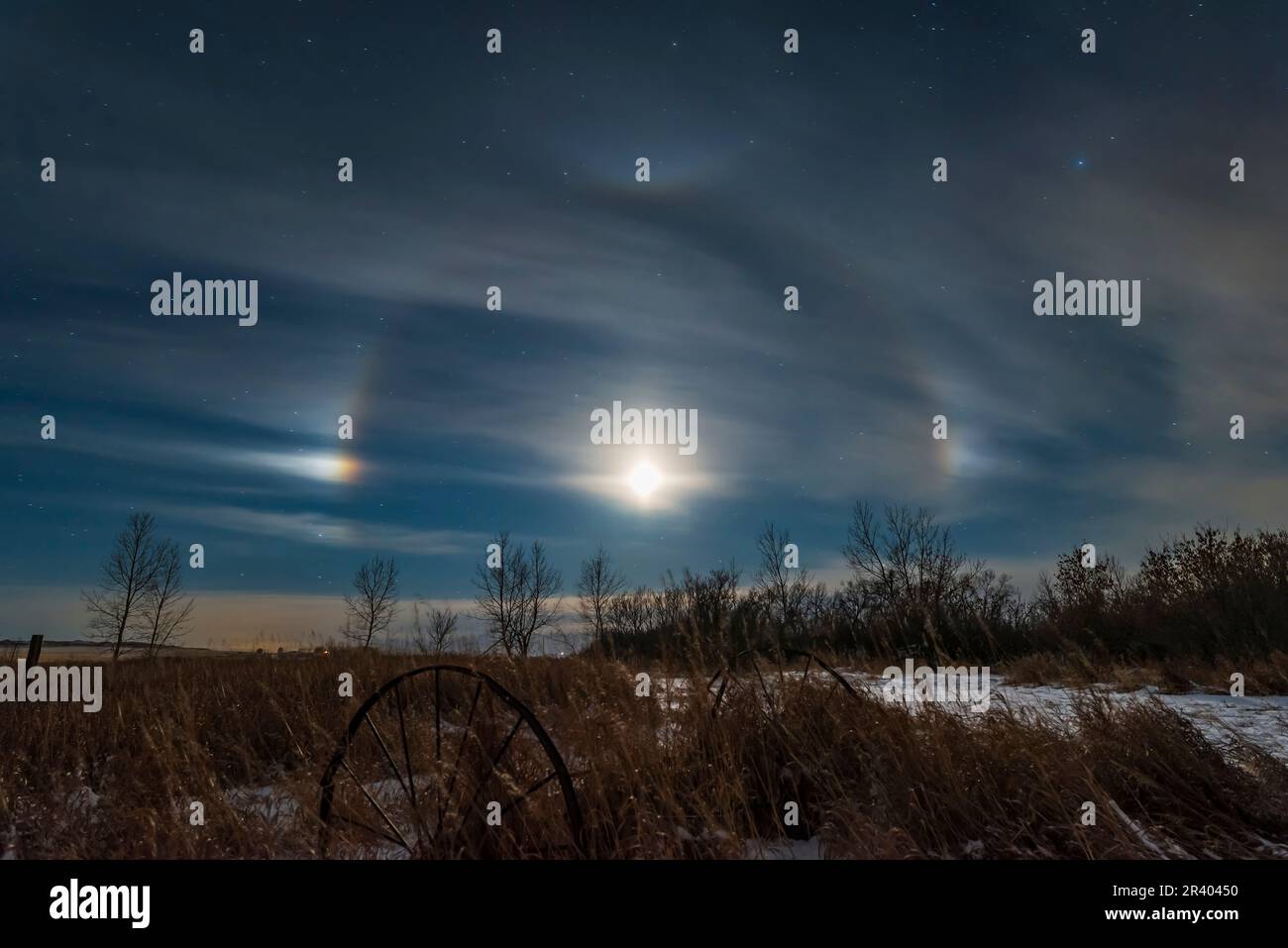 Moondogs around the waxing crescent moon with a lunar halo, Alberta, Canada. Stock Photo