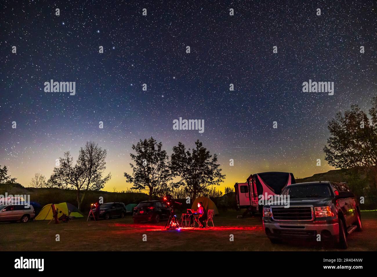 An observer at the Alberta Start Party, Canada. The Big Dipper is at upper left, with a mild auror on horizon. Stock Photo