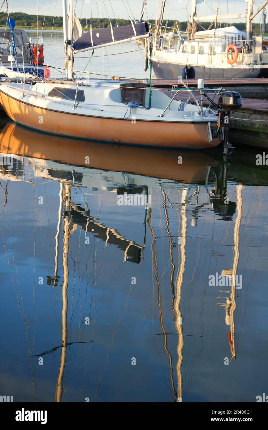 Boats reflected in water Stock Photo - Alamy