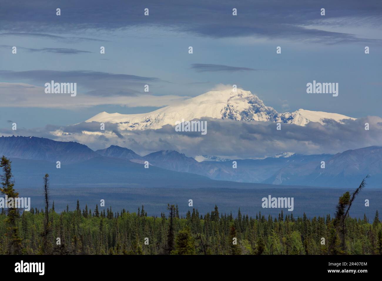 Picturesque Mountains of Alaska in summer. Snow covered massifs, glaciers and rocky peaks. Beautiful natural background. Stock Photo