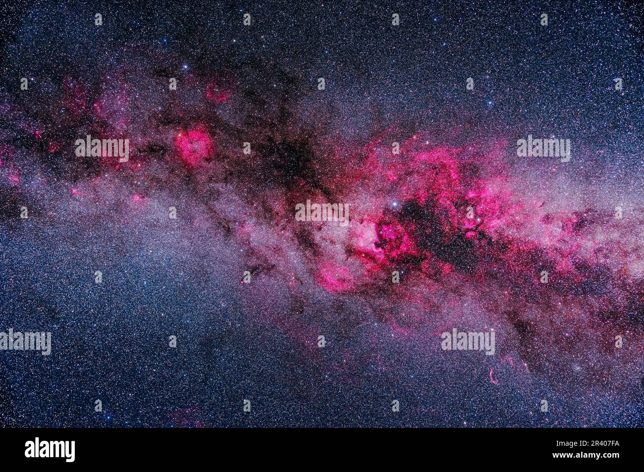 A framing of the major areas of bright and dark nebulosity in Cygnus and Cepheus, showing pink emission nebulas contrasting with dark dusty regions in Stock Photo