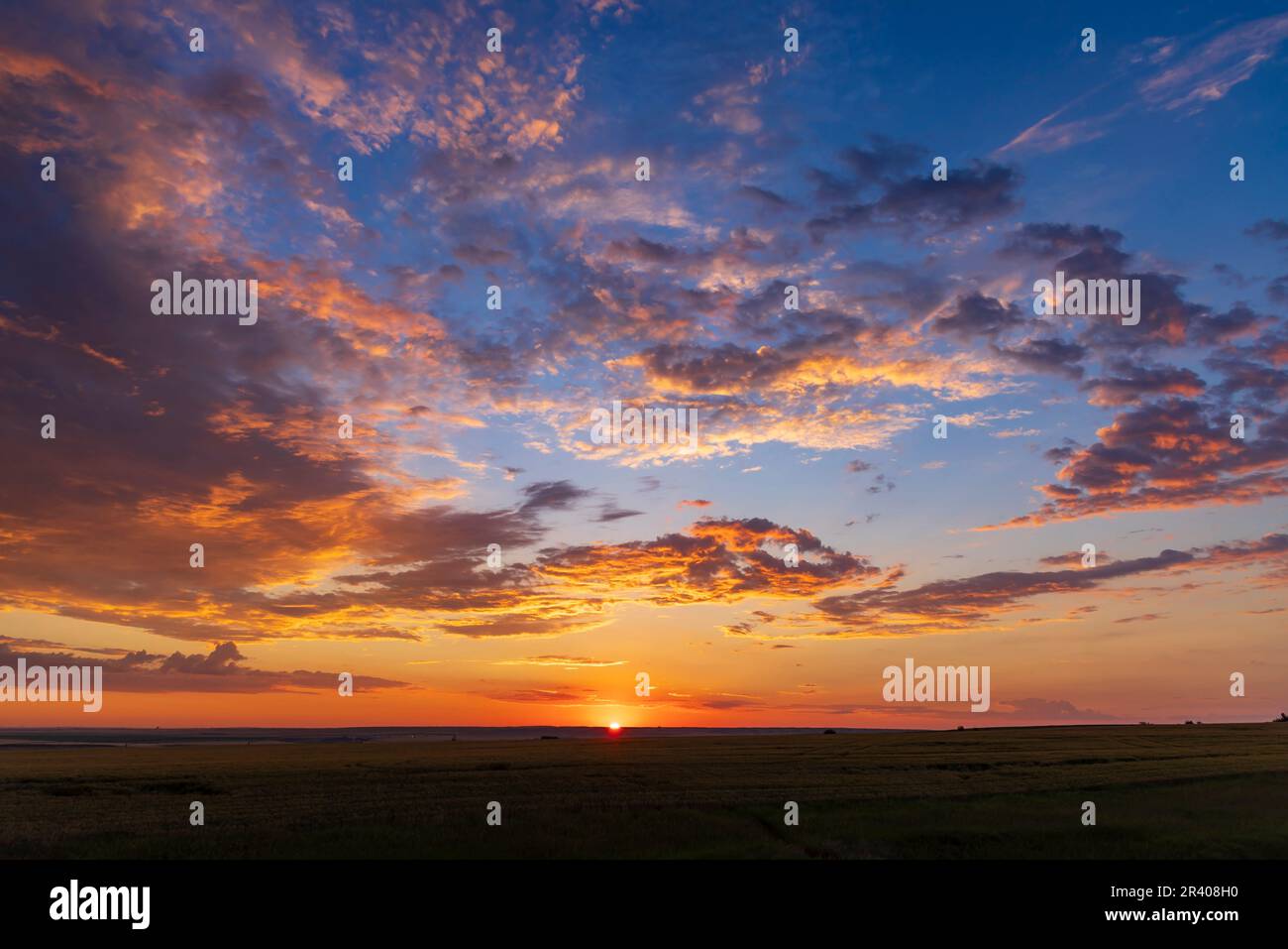 A colorful sunrise scene taken on an Alberta prairie just as the Sun came up. Stock Photo