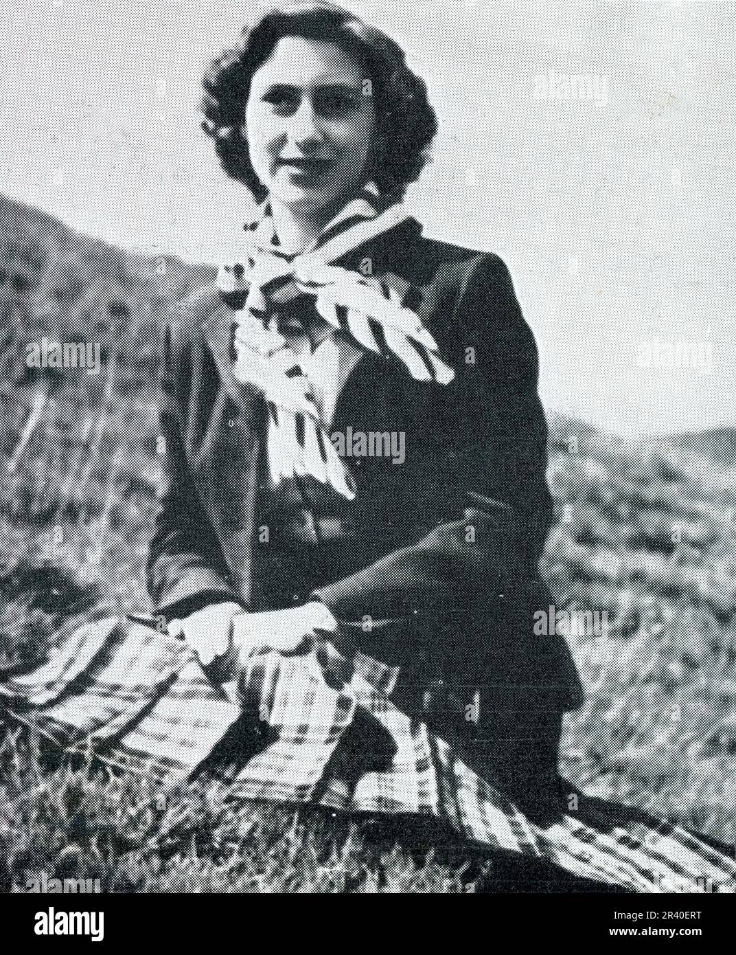 A relaxed informal photograph of HRH Princess Margared, wearing a kilt, on the moors near Balmoral, Scotland,  in August 1951 just a few months before the King's early death in February 1952, aged just 56. The royal family frequently had picnincs on the moors when out shooting. This photograph was taken by the Earl of Dalkeith, who later became the 9th duke of Buccleuch. Scotland, U.K. Stock Photo