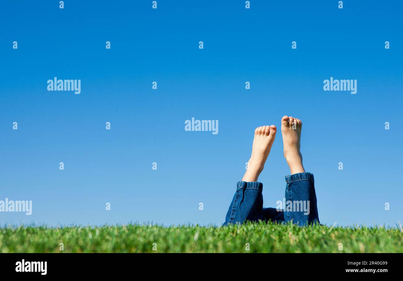 Kid laying in grass hi-res stock photography and images - Alamy