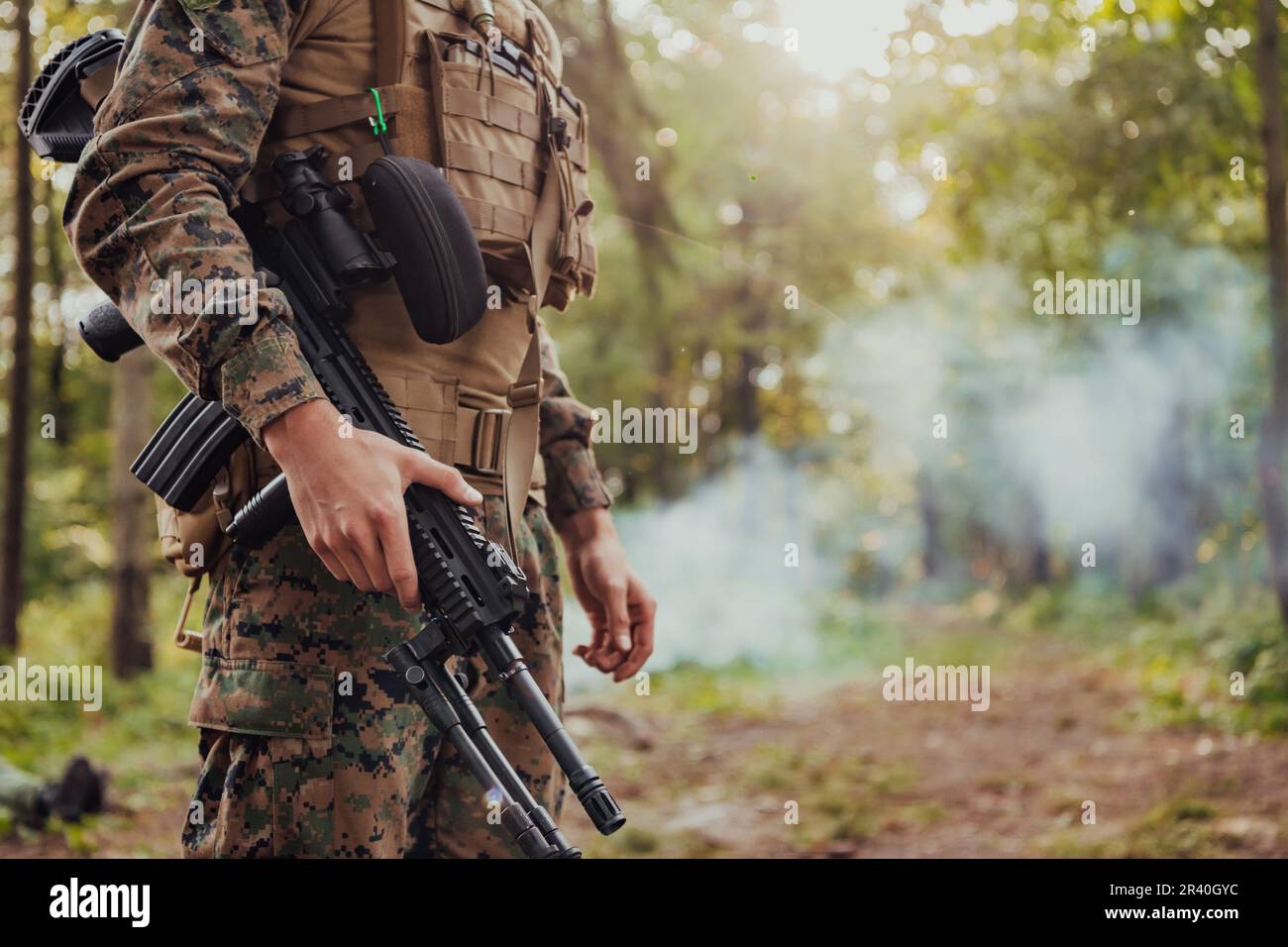 Soldier portrait with protective army tactical gear and weapon having a break and relaxing Stock Photo