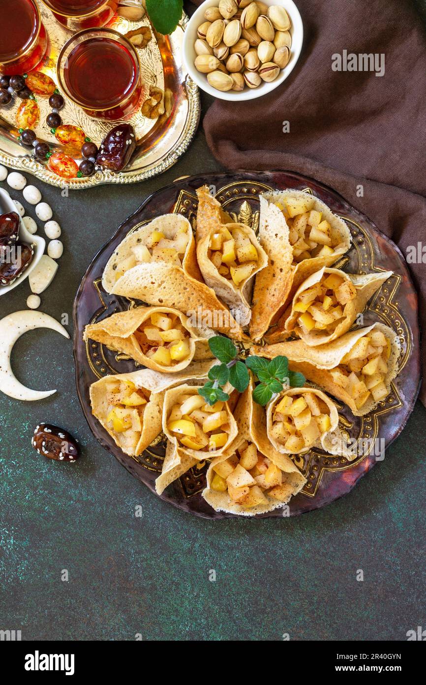 Arabic Cuisine. Ramadan Kareem Festive. Ramadan menu, arabian pancake katayef (katayev, qatayef) with apple filling and cinnamon Stock Photo