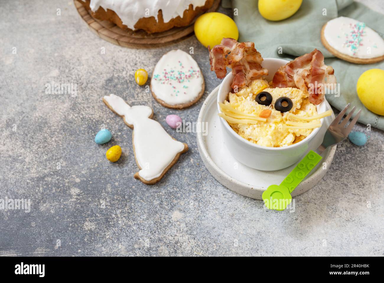 Easter breakfast idea. Scrambled eggs easter bunny on a stone background. Copy space. Stock Photo