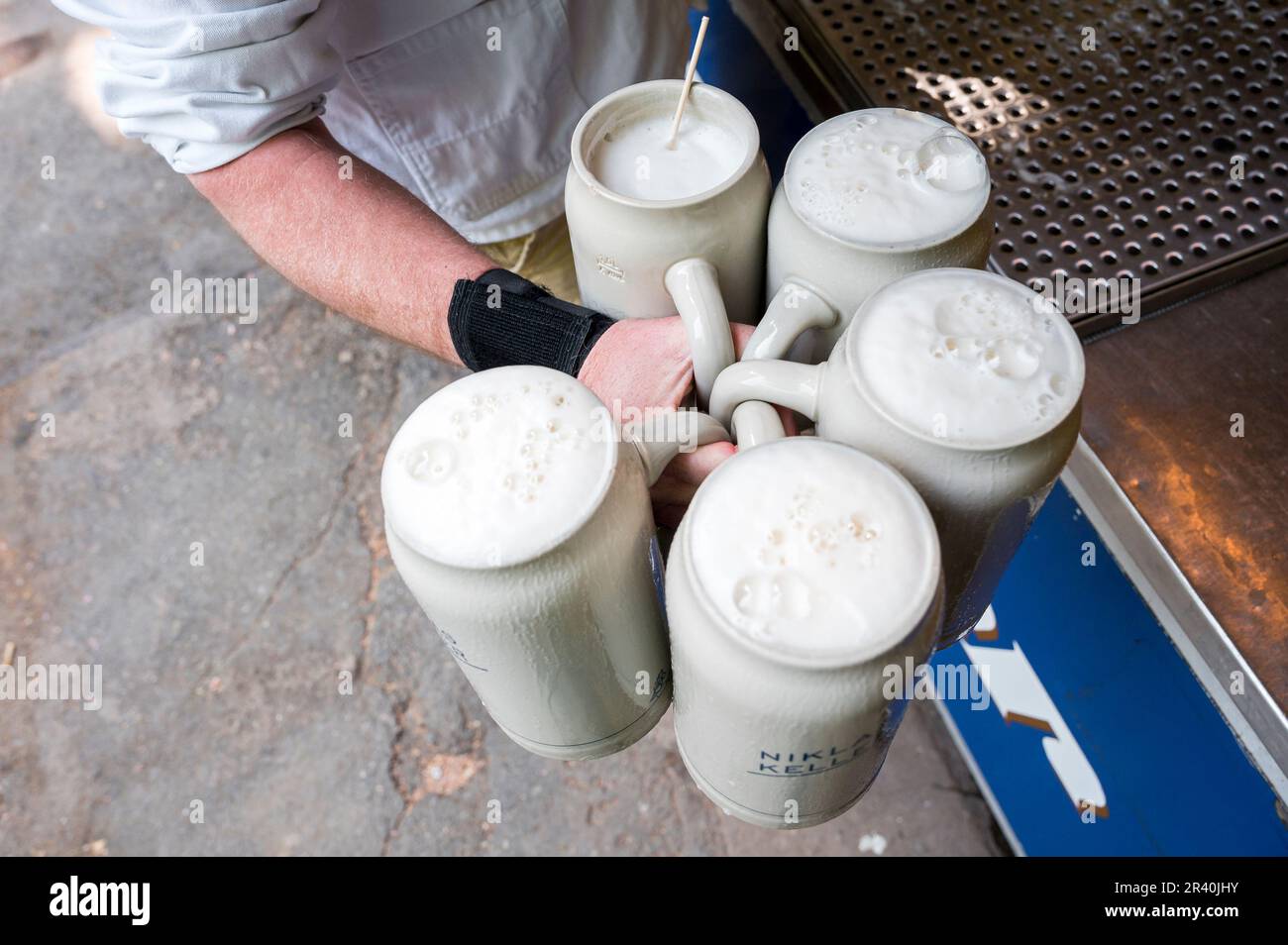 Erlangen, Germany. 25th May, 2023. A waiter holds 5 measures of beer from the Niklas Brewery. In