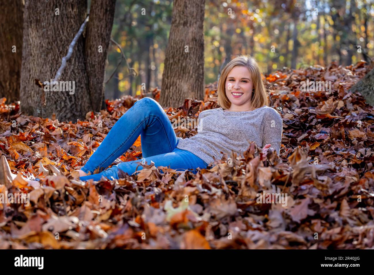 A gorgeous blonde model enjoys the outdoor fall weather Stock Photo
