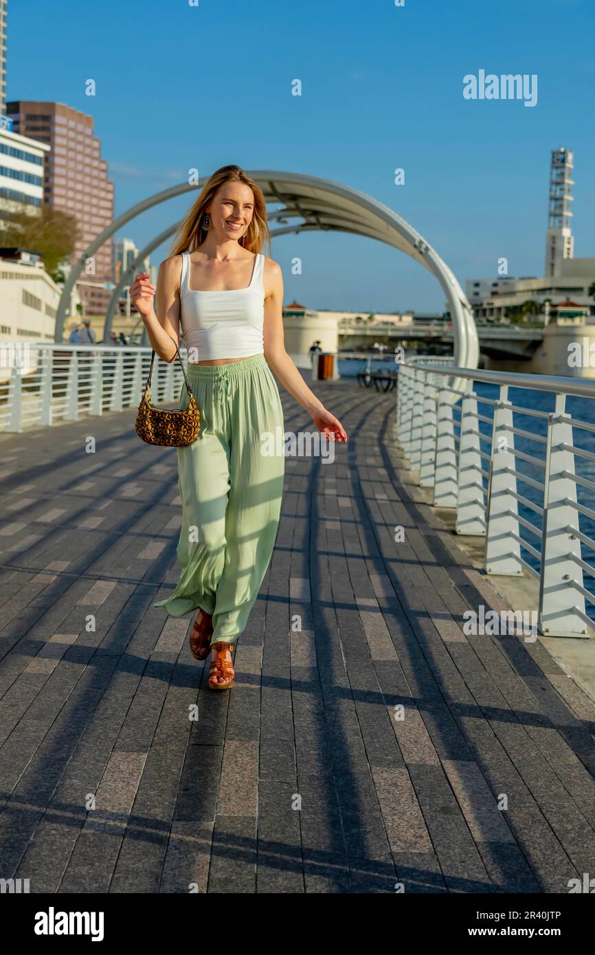 A gorgeous blonde model enjoys the beautiful weather in a major city Stock Photo
