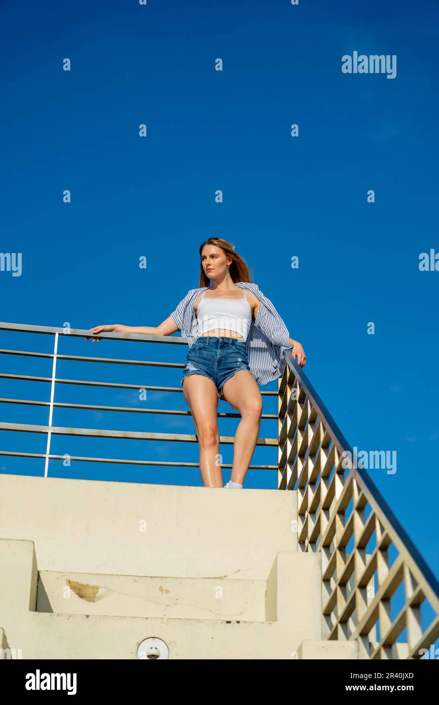 A Lovely Blonde Model Enjoys The Summer Weather In An Urban Environment Stock Photo