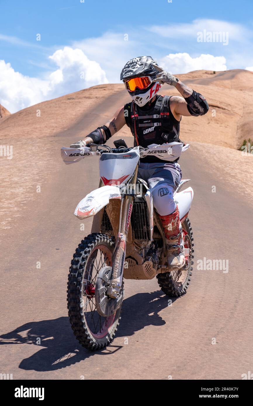 Off road motorcycle riding over the sandstone domes of the Fins