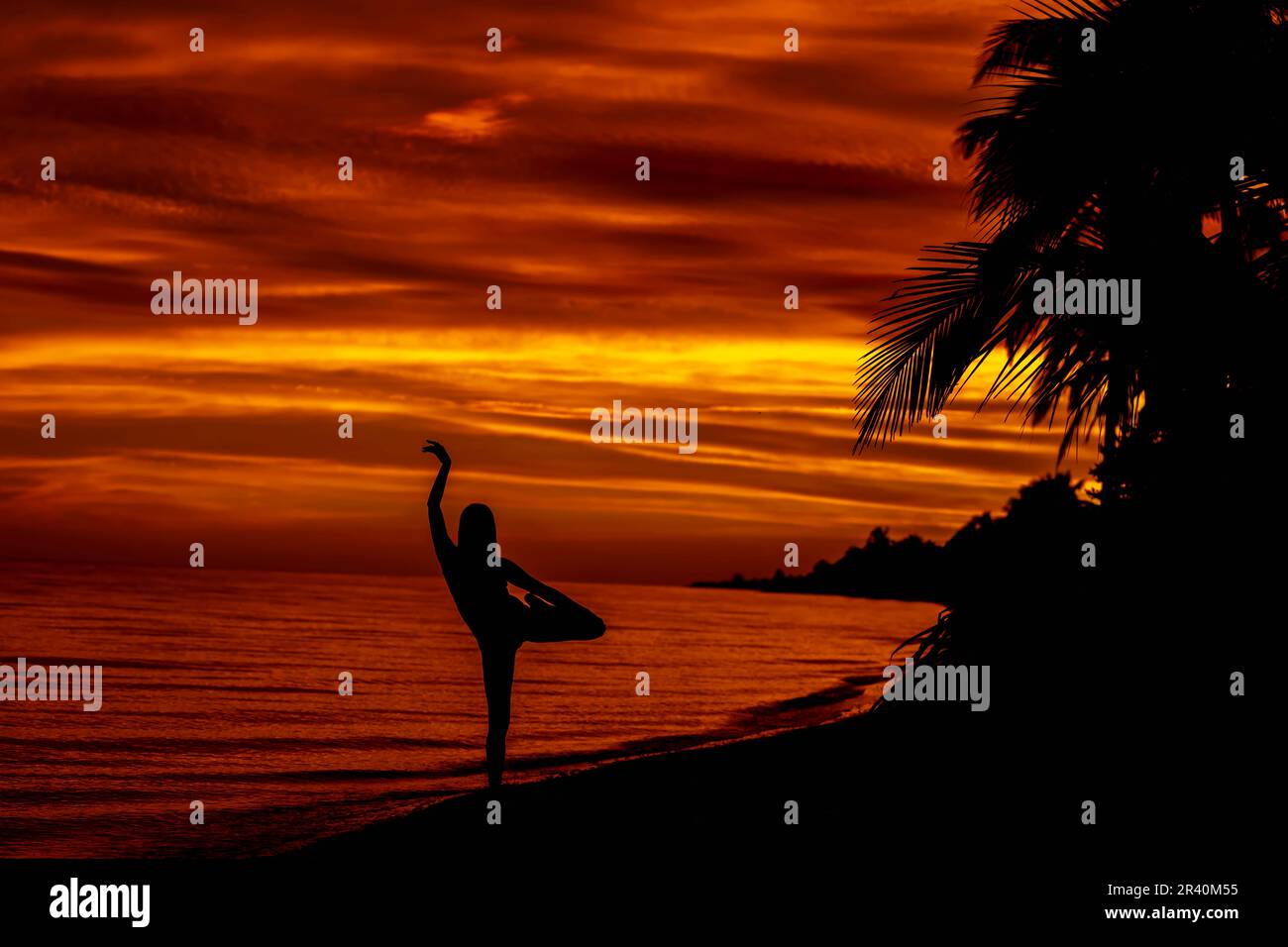 A Nude Latin Model Poses Against The Colorful Sky As The Sun Rises On The Pacific Ocean In Baja California Stock Photo