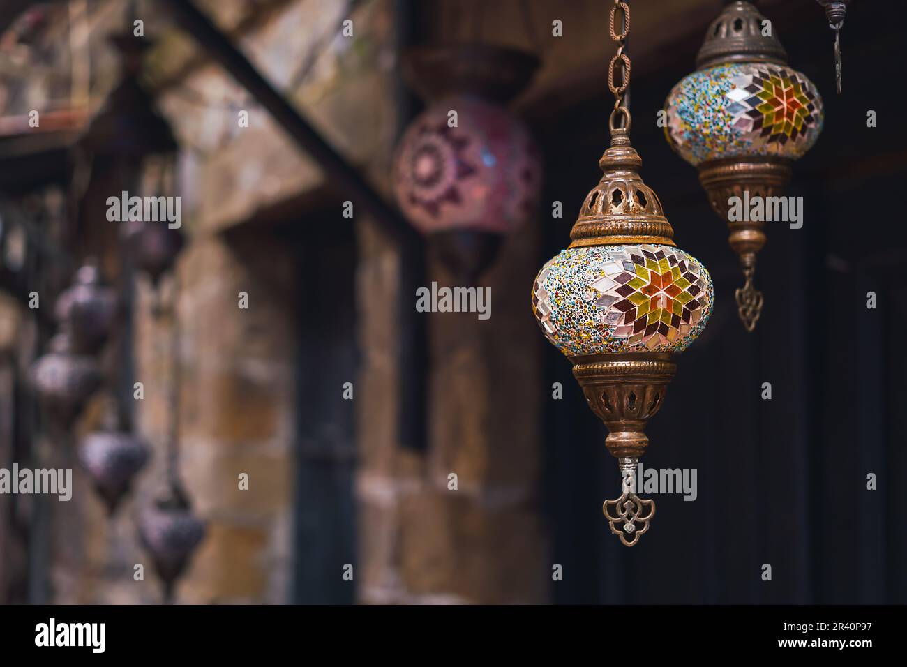 handmade traditional colorful Turkish lamps and lanterns, selective focus on lantern, blurred background, popular souvenir lanterns hanging in shop fo Stock Photo