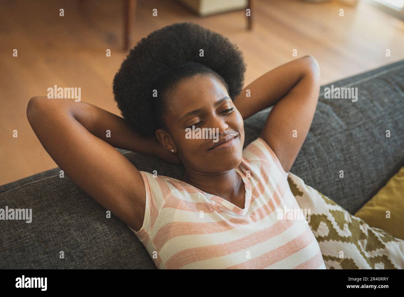 African american woman sitting on sofa relaxing with eyes closed Stock ...