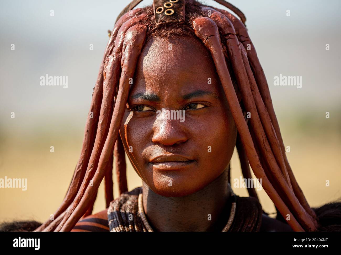 Portrait of a young woman of the Himba tribe with a traditional ...