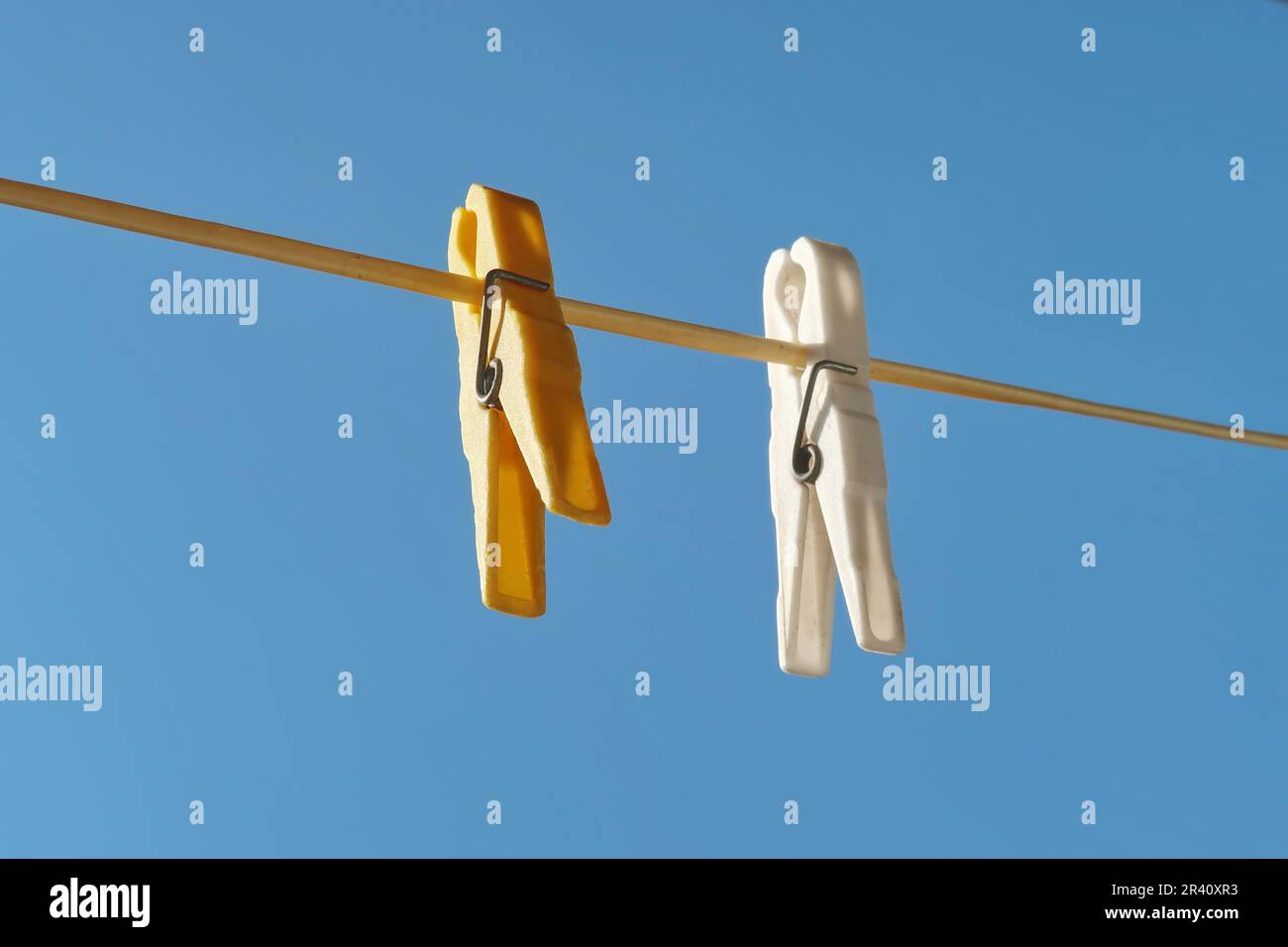 Clothespins on rope and blue sky Stock Photo