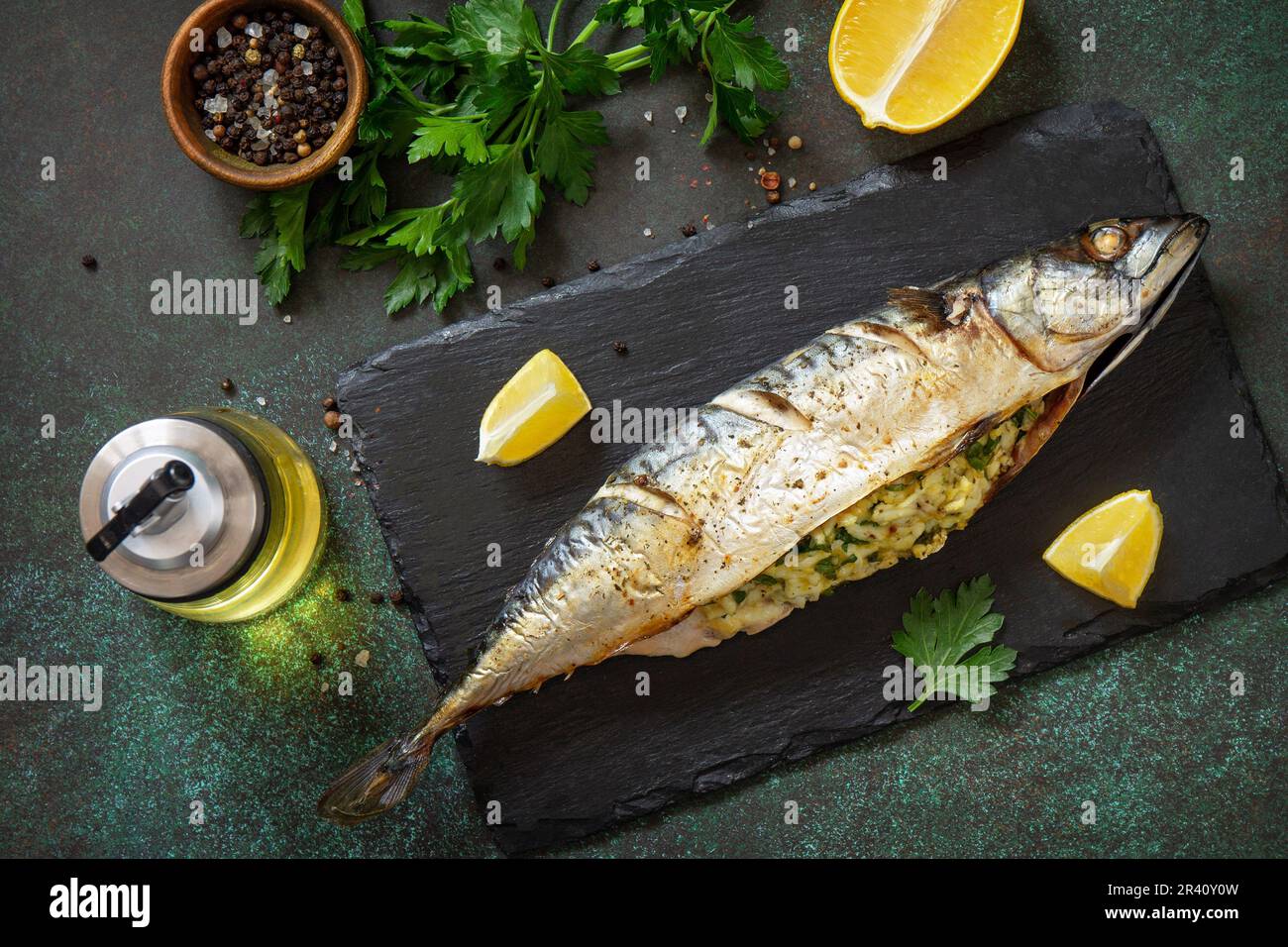 Grilled baked mackerel stuffed with cheese and egg on a stone