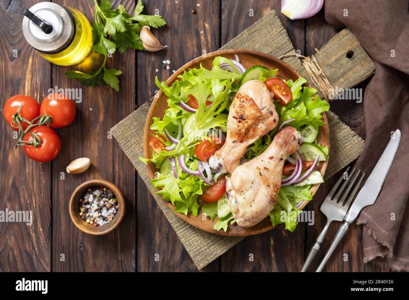 Grilled chicken meat with fresh green lettuce, cucumbers, tomato and