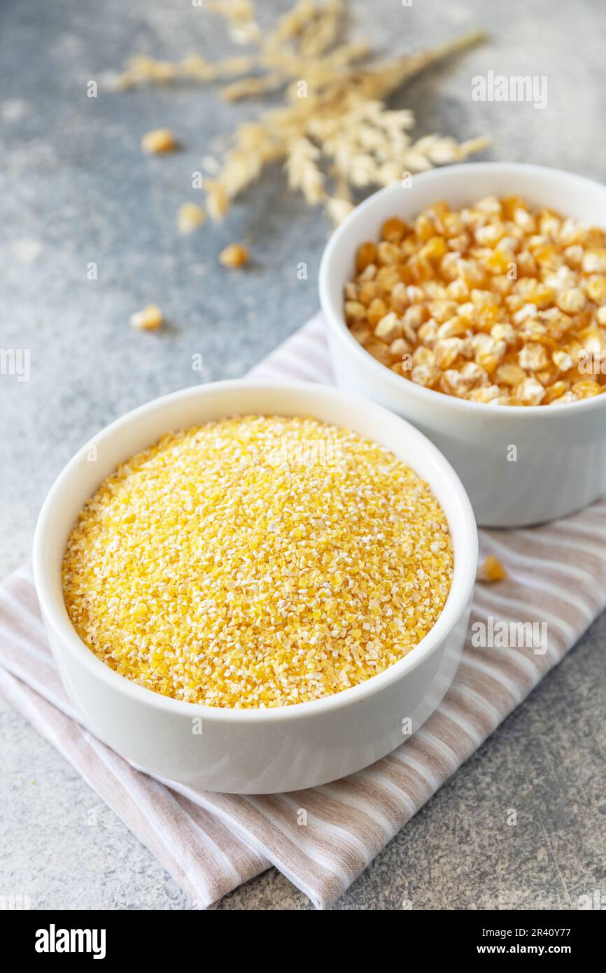 Food gluten free ingredient. Corn groats and seeds over gray stone background. Stock Photo