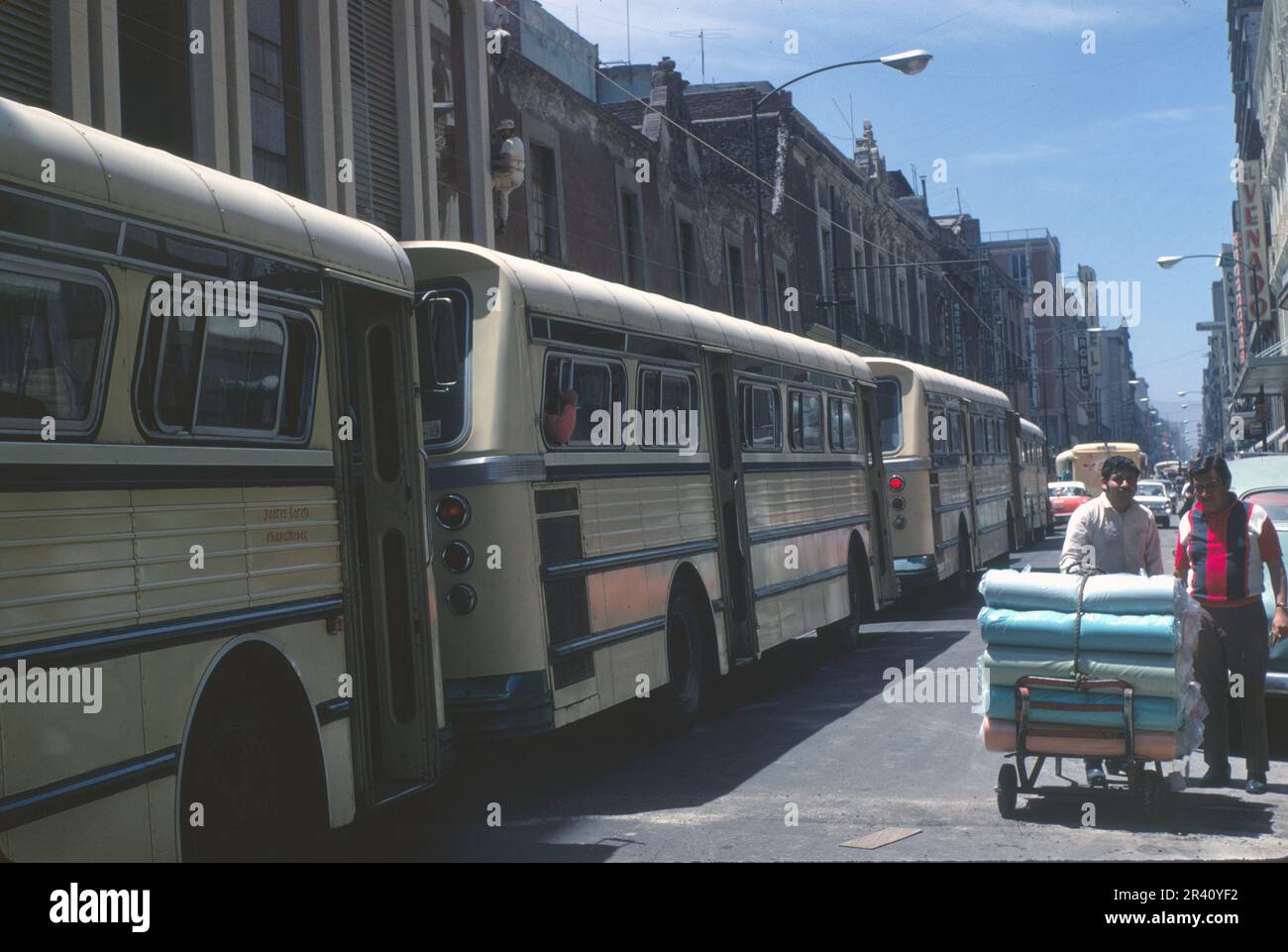 Mexico City, Mexico- April 1970: Tour buses line República de Uruguay street in historic center of Mexico City, Hotel Roble in distance, vintage slide Stock Photo