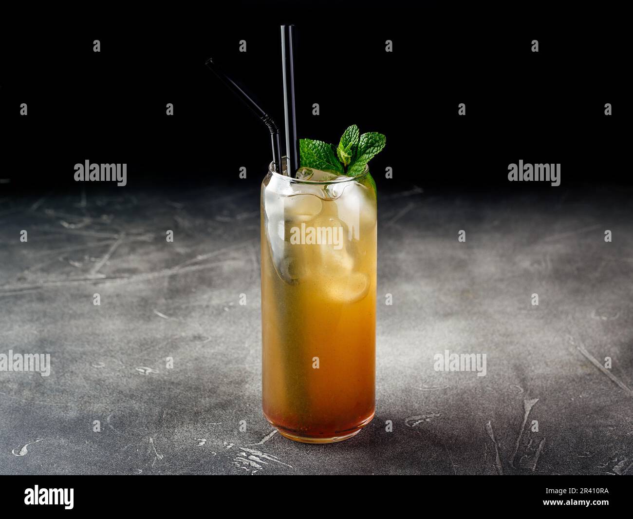 Cold alcoholic or non-alcoholic cocktail with ice on dark background Stock Photo