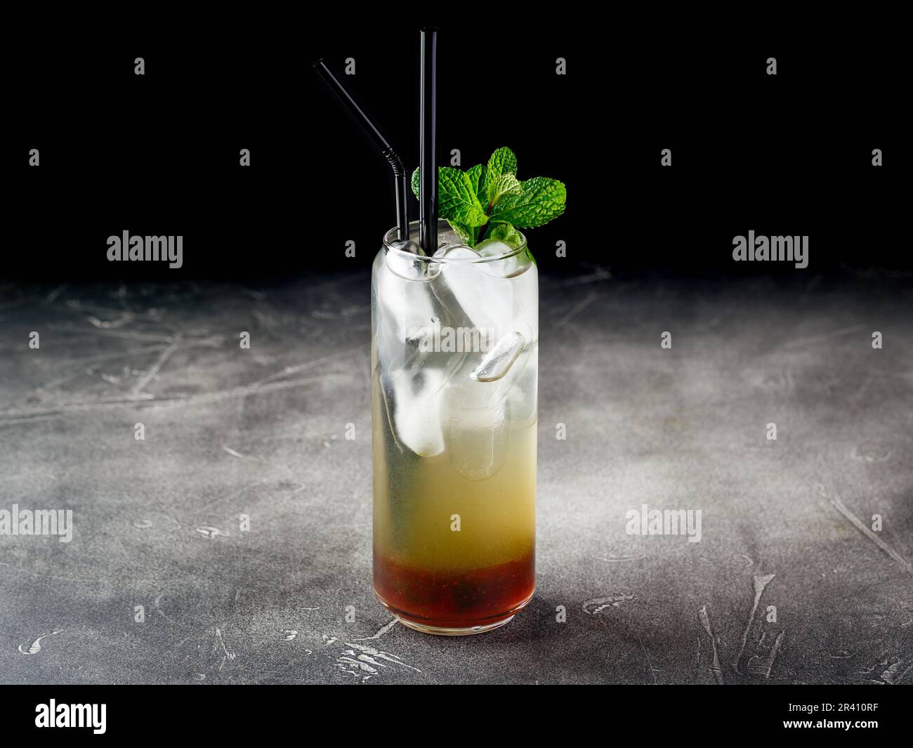 Cold alcoholic or non-alcoholic cocktail with ice on dark background Stock Photo