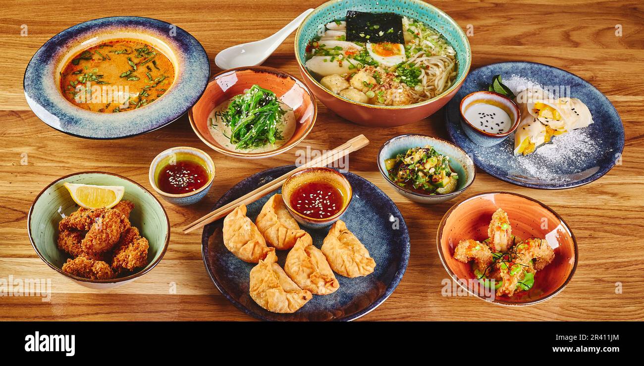 Set of assorted pan asian dishes. Chinese, Korean, Japanese cuisine. Soups, dumplings, noodles, rice and desserts. Stock Photo