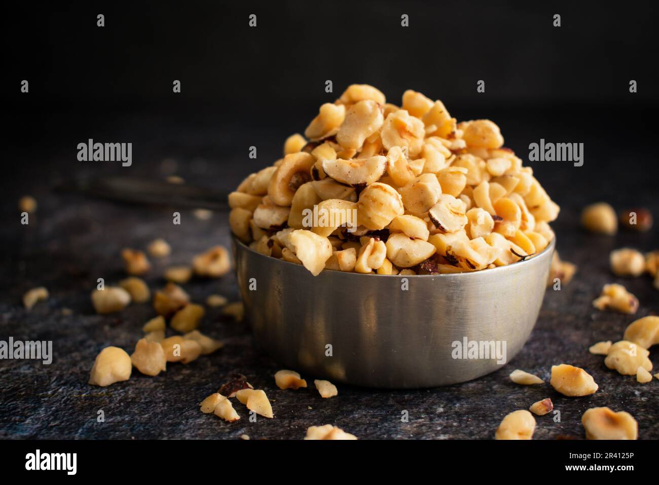 Toasted Hazelnuts in a Stainless Steel Measuring Cup Overhead view of