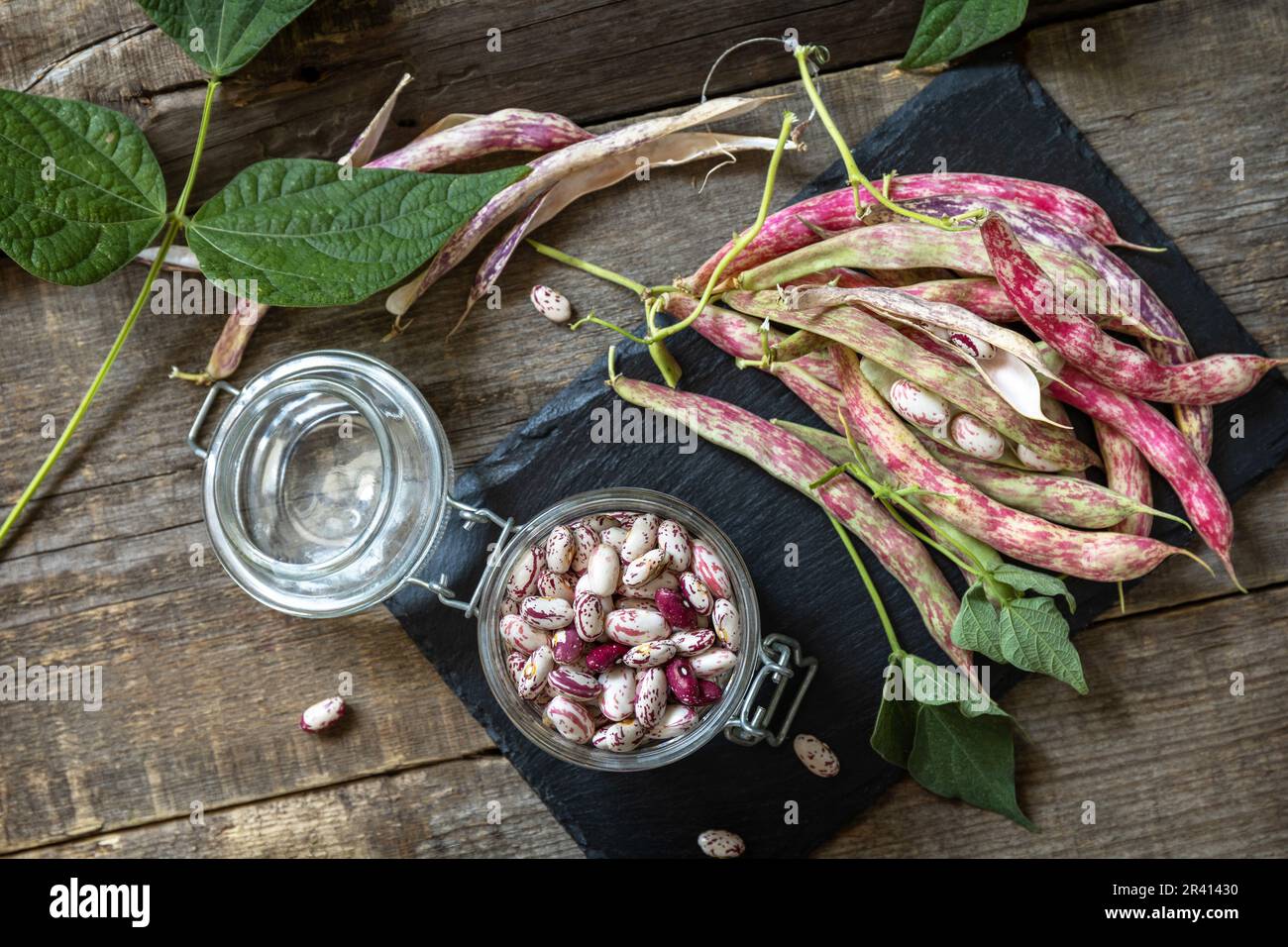 Beans of bean, brown bean (of dried beans) in a glass jar on a rustic ...