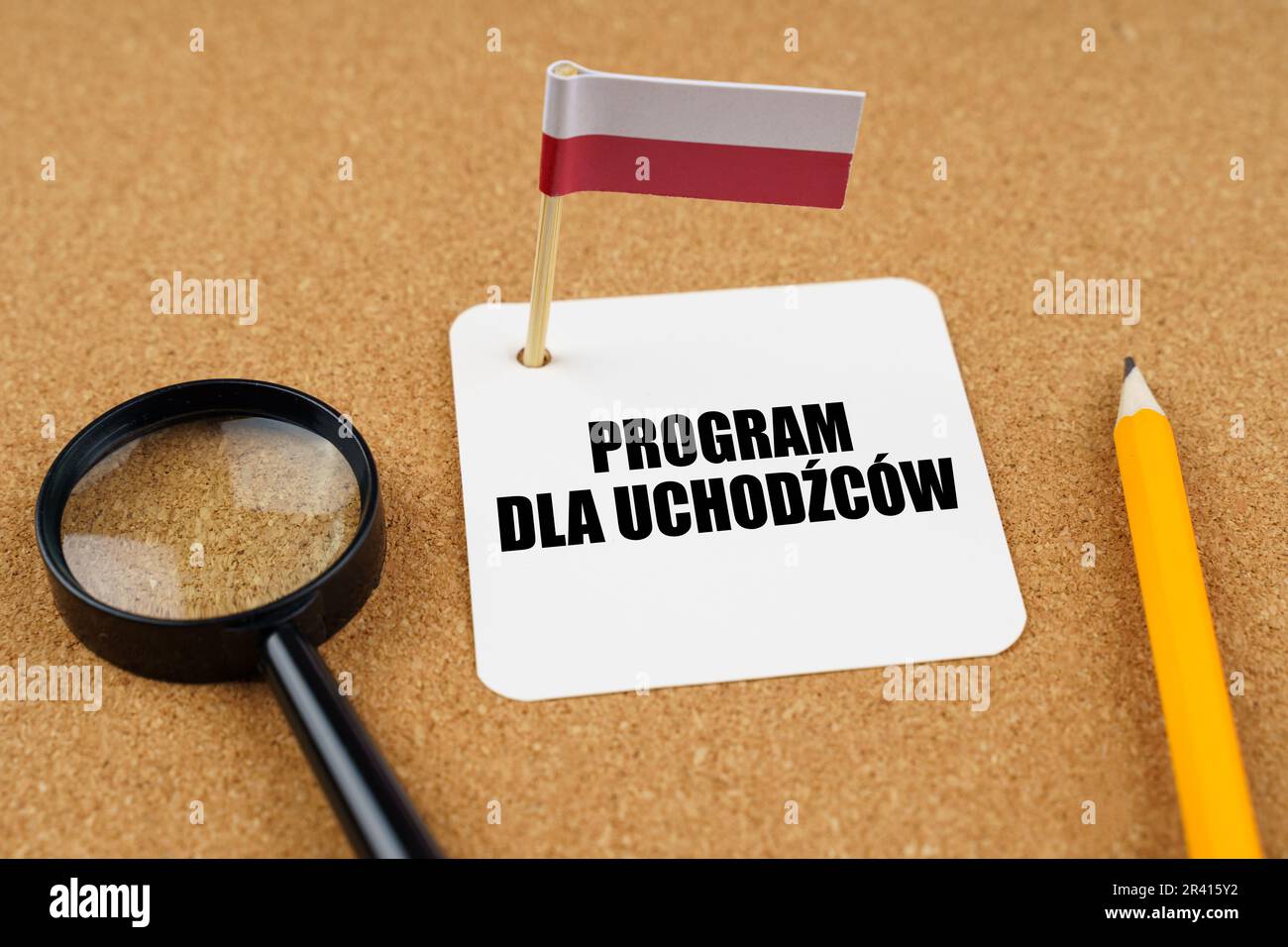 On the table is the flag of Poland, a pencil, a magnifying glass and a sheet of paper with an inscription in Polish which translates into English as - Stock Photo