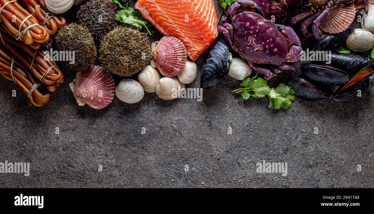 PACIFIC SEAFOOD. Fresh salmon, crabs ostions clams mussels, seaweed cochayuyo, sea urchins. Food background with copy space Stock Photo