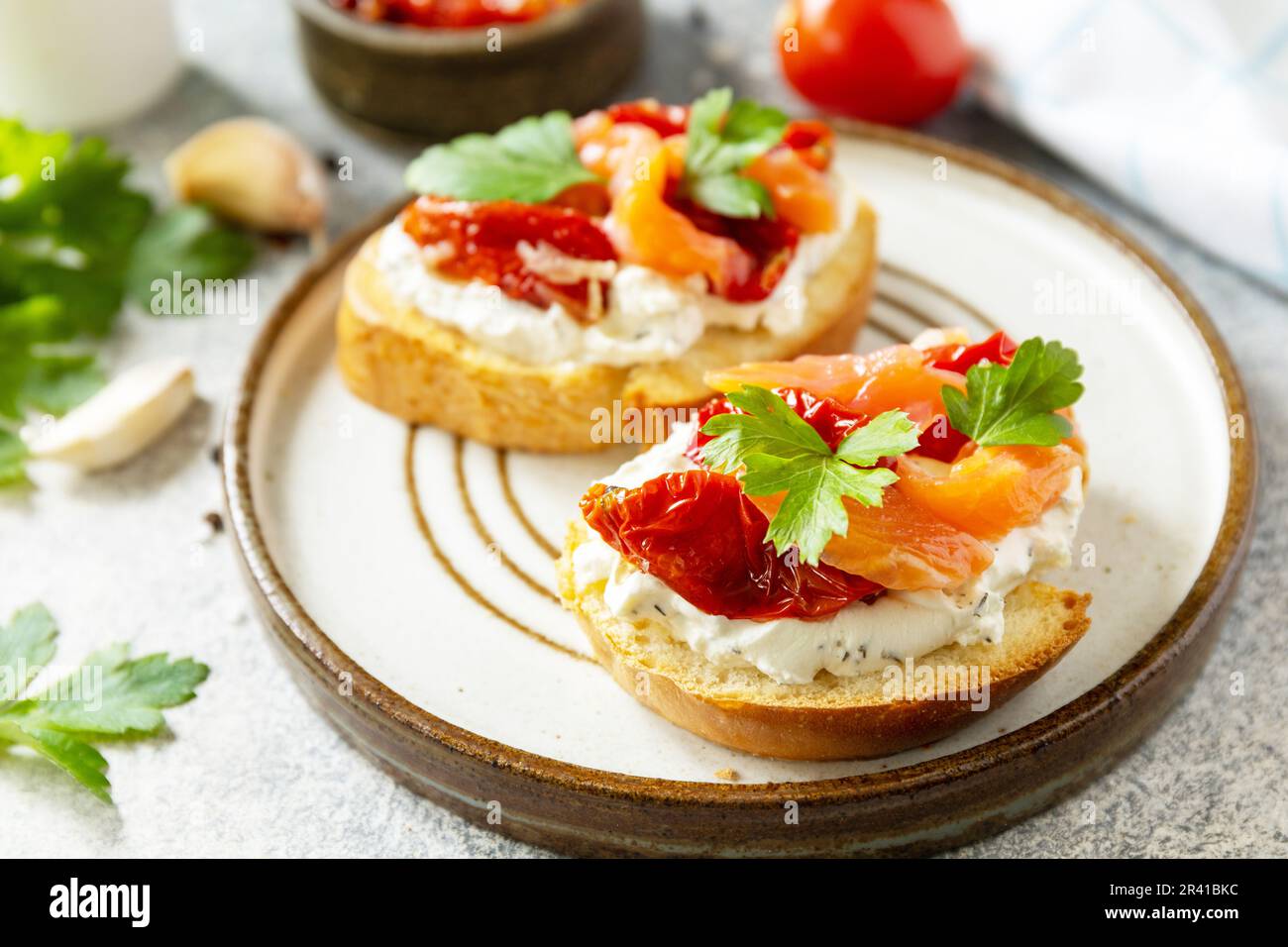 Open sandwiches or bruschetta with salted salmon, cheese and sun dried