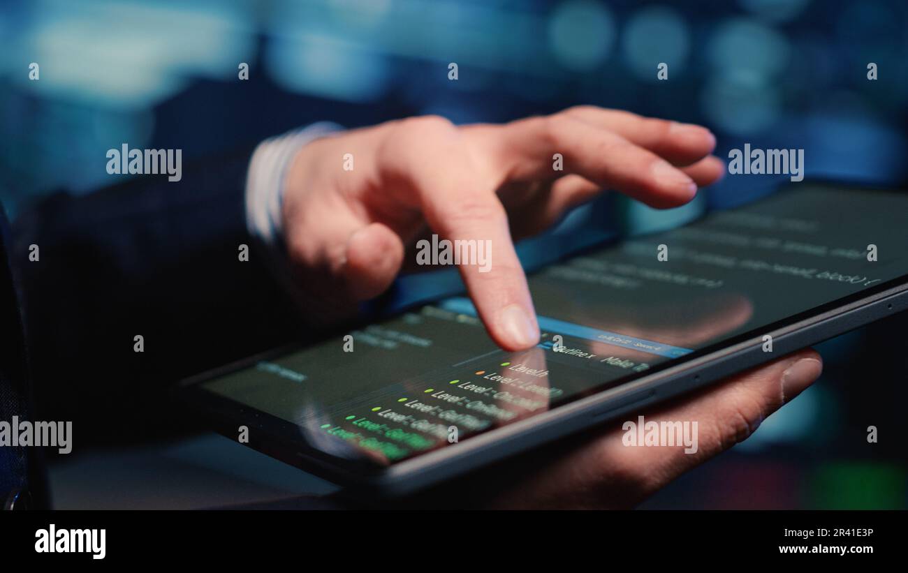 Male system administrator inspecting big data on tablet Stock Photo