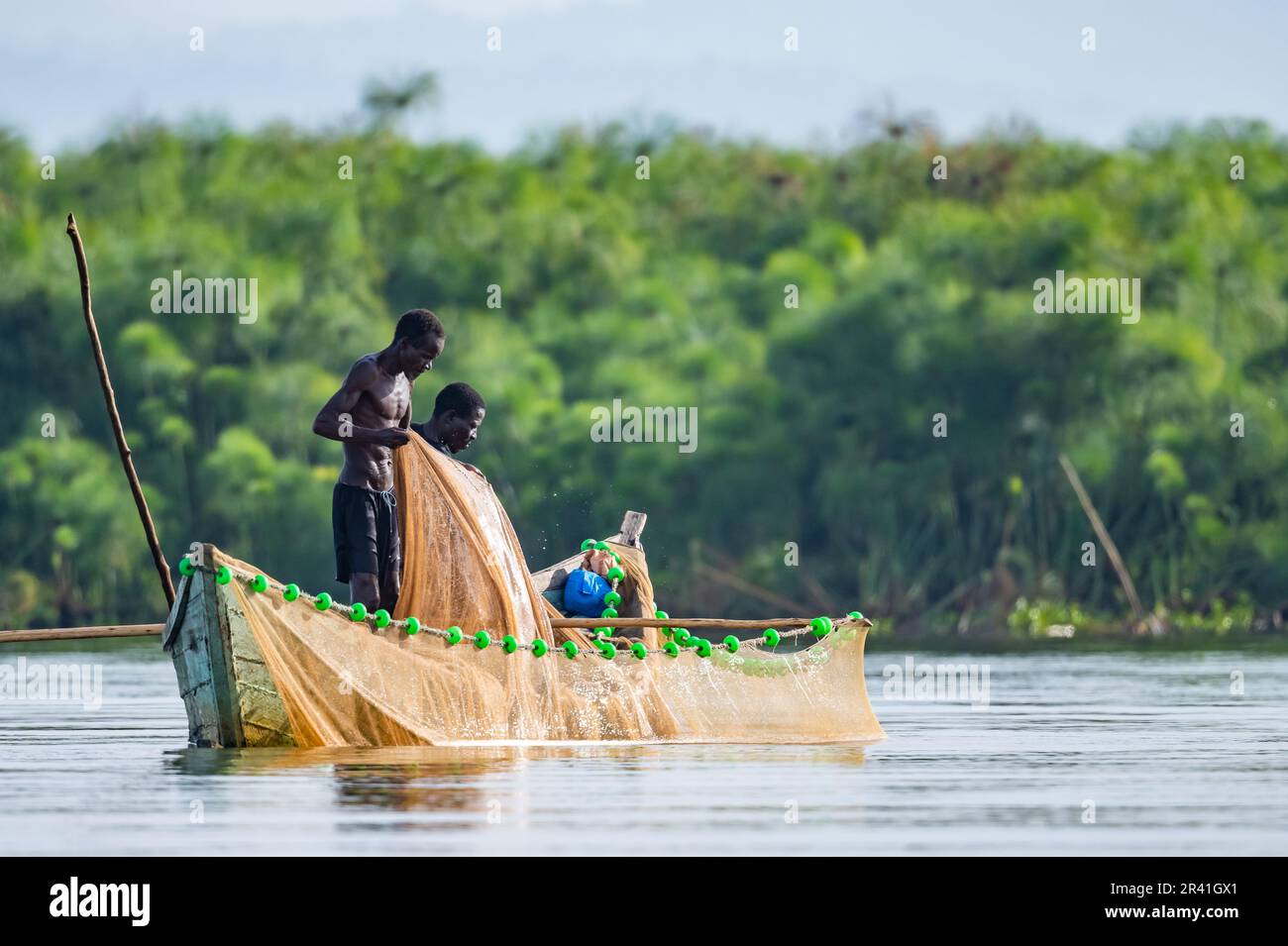 Two local men fishing in a small boat on Lake Victoria. Kisumu