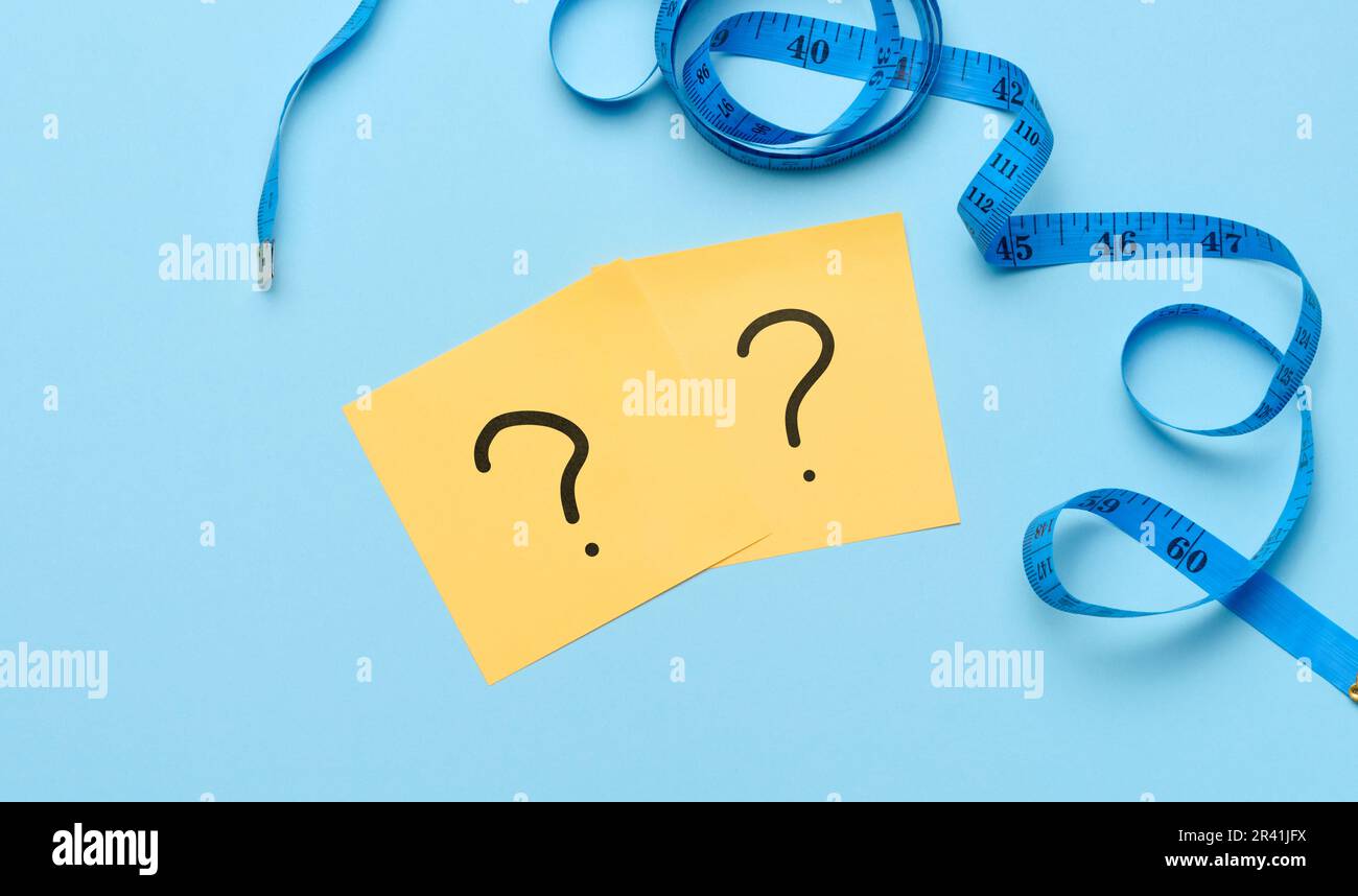 Measuring tape and stickers with question marks, weight loss concept