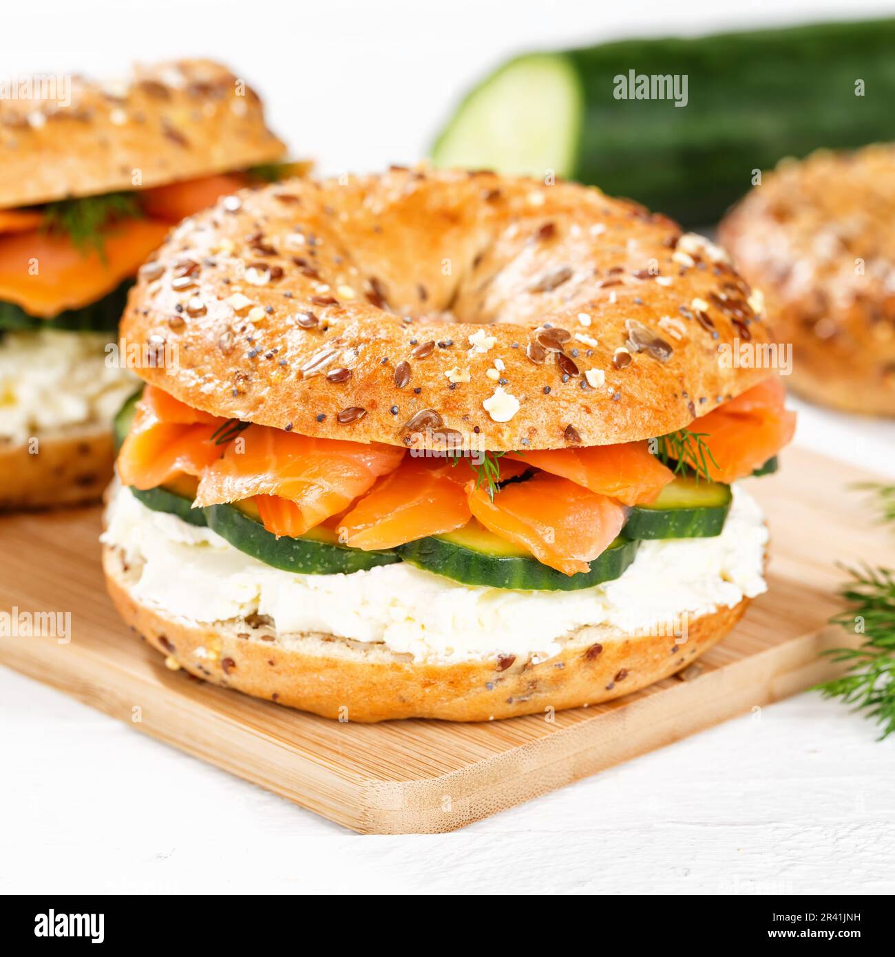 Bagel roll sandwich for breakfast topped with salmon fish on a board