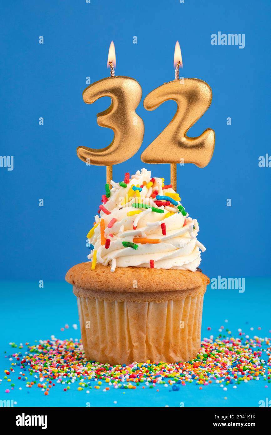 Birthday cake with candle number 32 - Blue background Stock Photo - Alamy