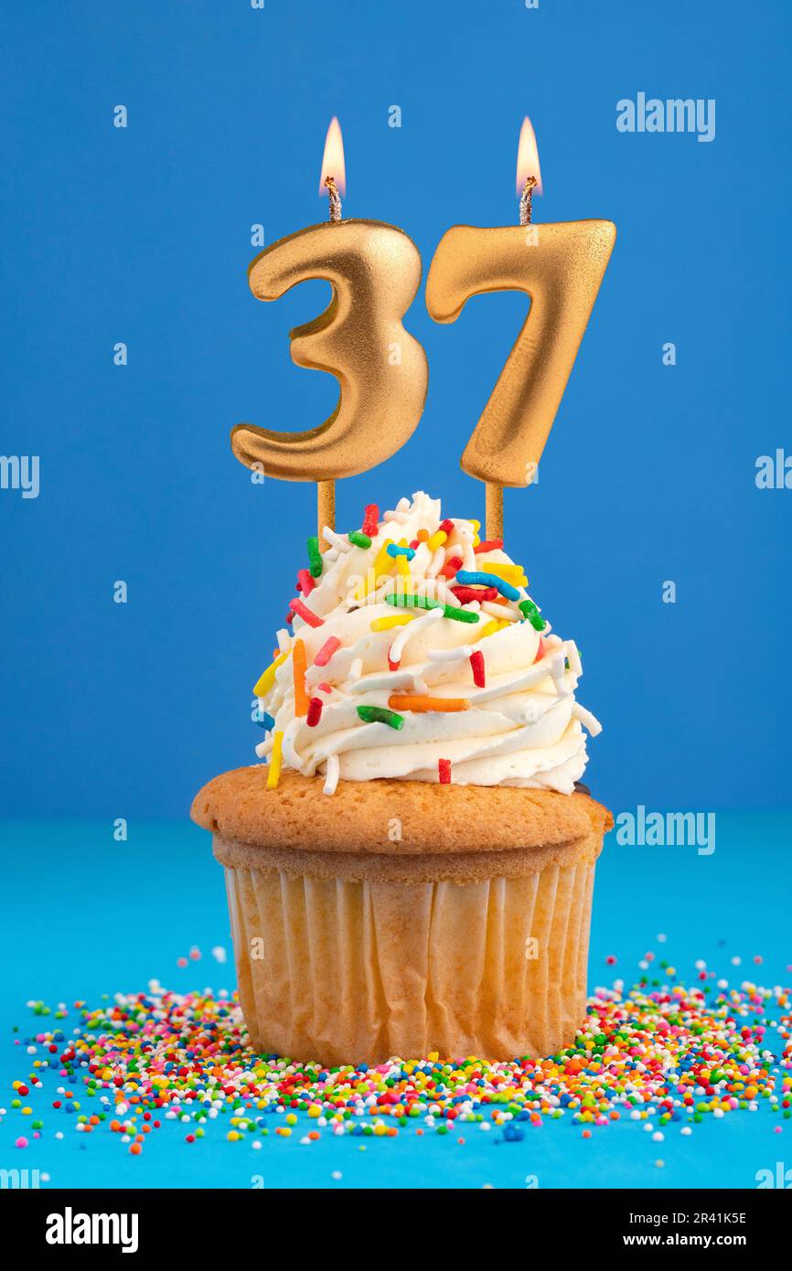 Candle number 37 - Cake birthday in blue background Stock Photo - Alamy