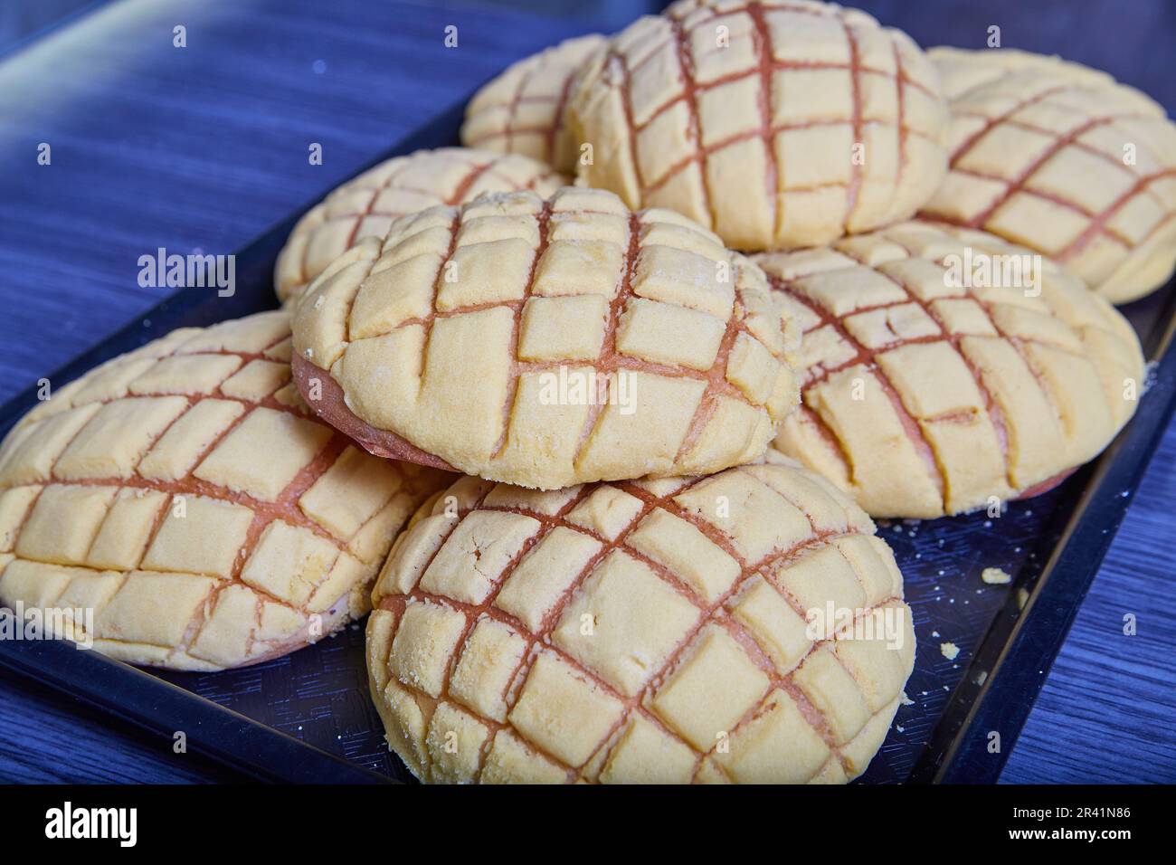 Tray of white vanilla conchas with melon bread scoring baked goods a