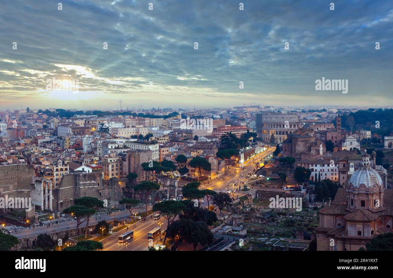 Ruins of Roman Forum. Rome City evening view from II Vittoriano top. People are unrecognizable. Stock Photo