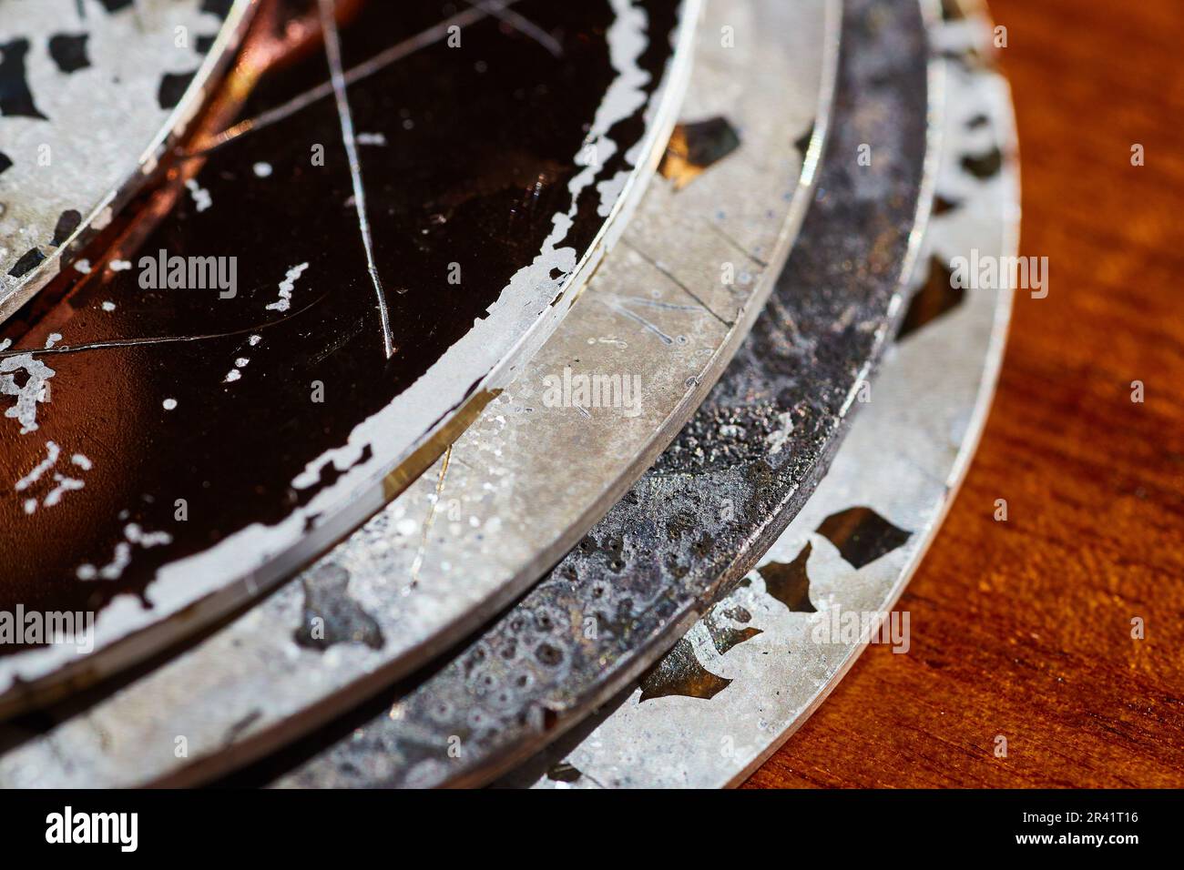 Cracked and chipped hard drive CDs after burning with textured surface background asset Stock Photo