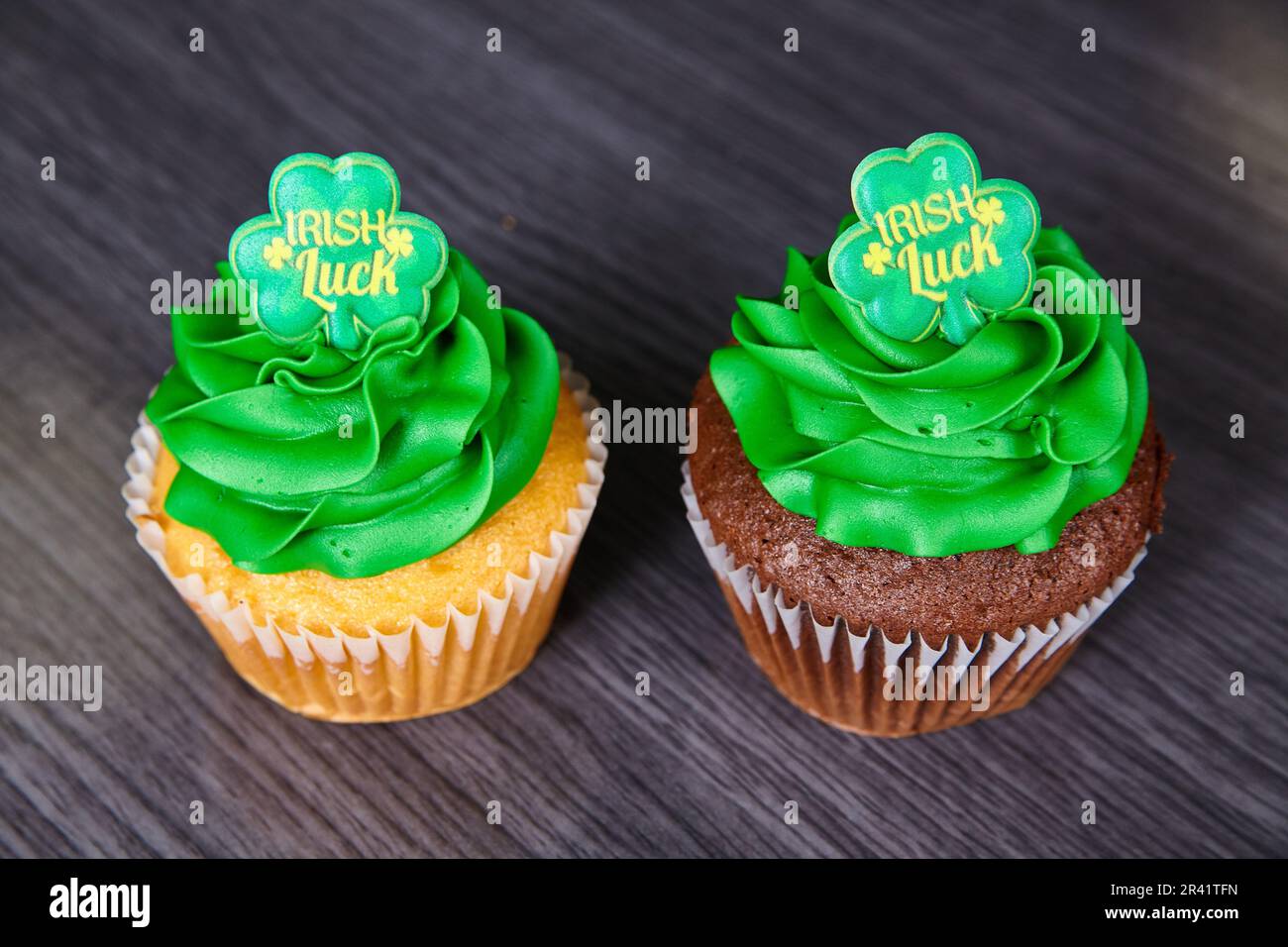 Vanilla and chocolate St. Patrick’s Day cupcakes green frosting Irish Luck four-leaf clover topper Stock Photo