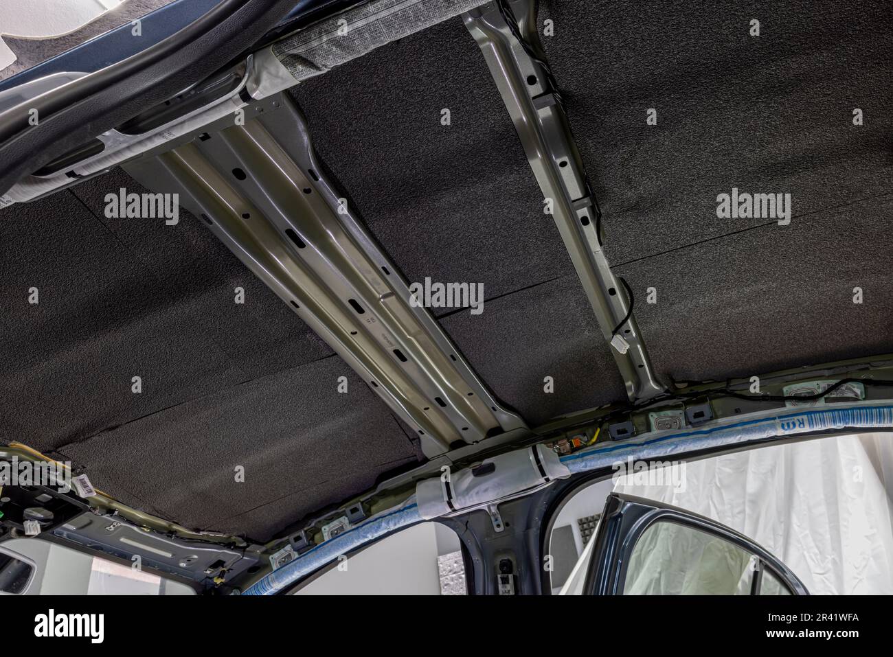 Roll of soundproofing material to car parts. The process of installing