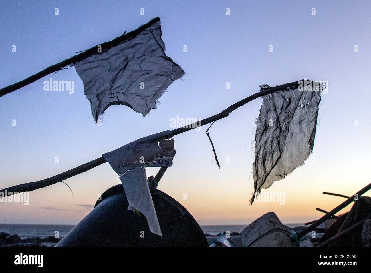 Tattered Fishing Flags Fluttering in the Wind at Sunset Stock Photo